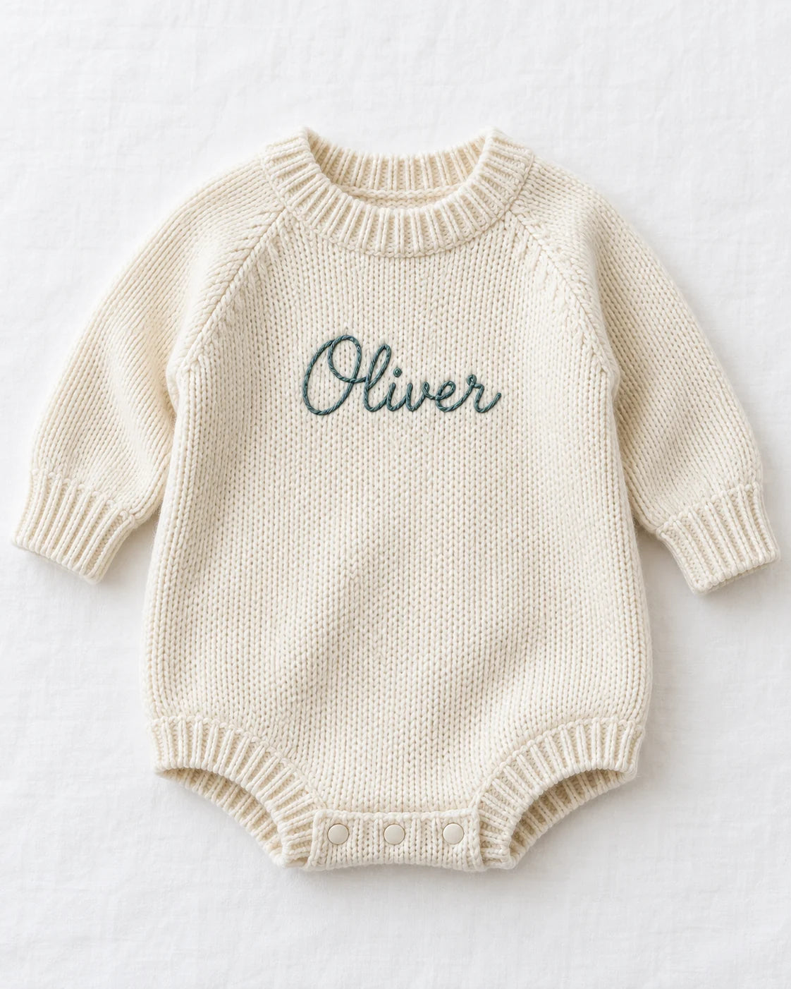 Personalized baby sweater romper, beanie and knit blanket concept